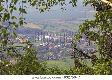 Aerial View Of A Village In The Frame Of Branches