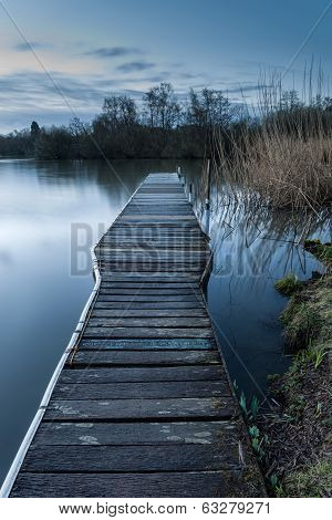 Calm Tranquil Moonlit Landscape Over Lake And Jetty