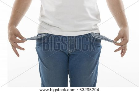 Man in blue jeans while shows his empty pockets