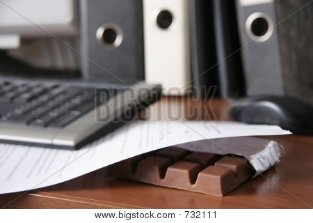 A Bar Of Chocolate On An Office Table.