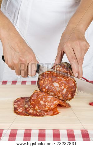 Butcher Slicing A Spanish Sausage Called Morcon