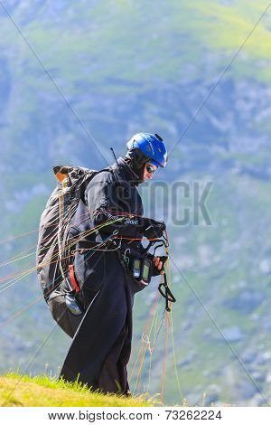 Unidentified paraglider in Balea Lake Fagaras Mountain Romania.
