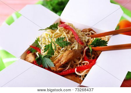 Chinese noodles in takeaway box closeup