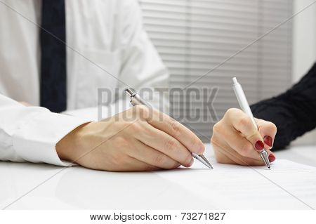 Business Partners Signing A Document