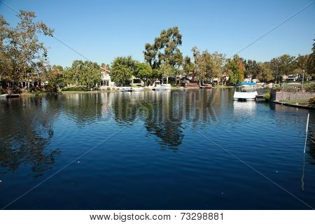 Private Lake with homes and boats in Lake Forest California. Lake Forest has many Private Lakes with limited access to the general public, making it an ideal and serene location to live life. 