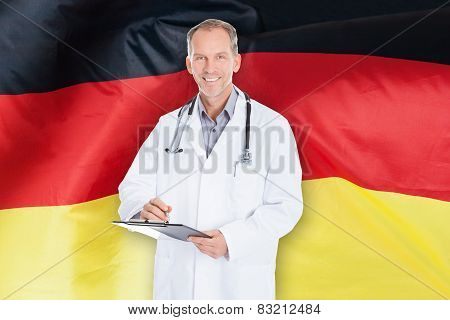Male Doctor Writing On Clipboard