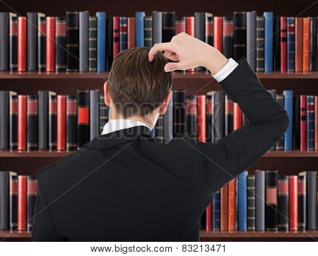 Young Man In A Suit Scratching His Head