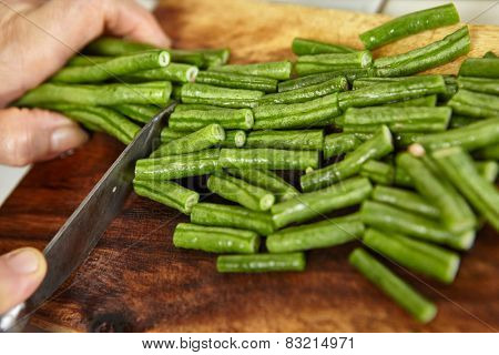 Hand cutting yardlong bean as ingredient for cooking