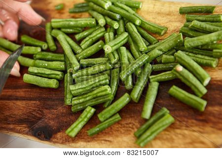 Hand cutting yardlong bean as ingredient for cooking