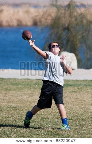 Boy Playing Football In The Park