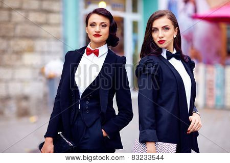 Two Gorgeous Women Posing In Black Suits