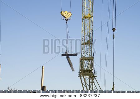 Construction site. Moving cargo tower crane