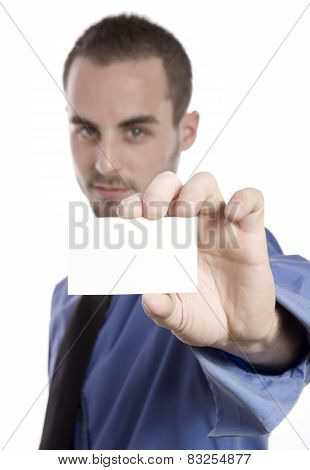 Concentrated young businessman using laptop and phone at office
