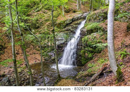 Waterfall flowing in a forest in autumn