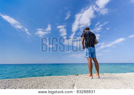 Fisherman fishing on a seaside
