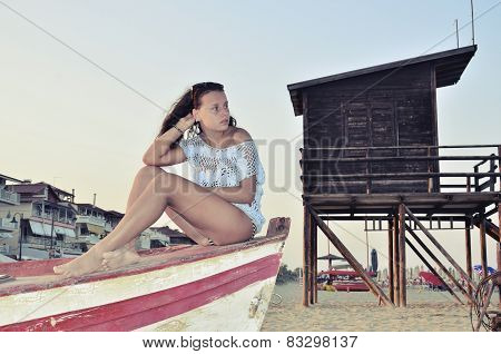 Beautiful girl sitting on a boat