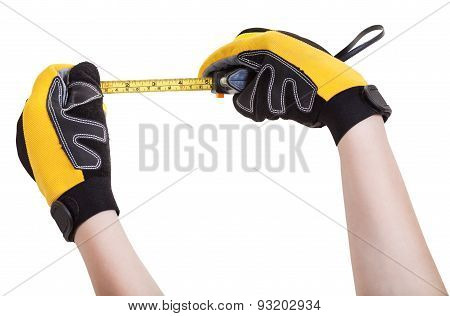 Hands In Protective Glowes With Tape Measure