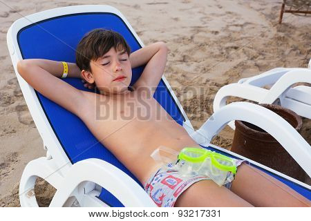 Preteen Handsome Boy Lay On The Beach With Snirkeling Mask  Get Sun Tan