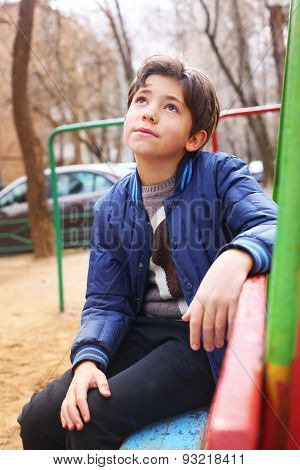 Handsome Preteen Boy Expressive Thoughtfull Portrait On The Playground