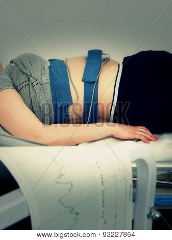 Pregnant woman at cardiography practice
