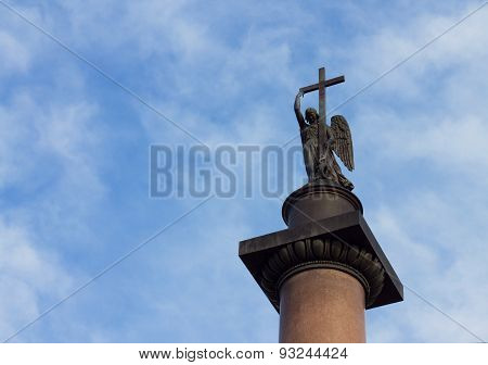 Angel With Cross Against Cloudy Blue Sky