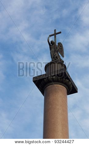 Angel With Cross Against Cloudy Blue Sky
