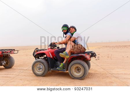 Young Couple Riding Sand Atv