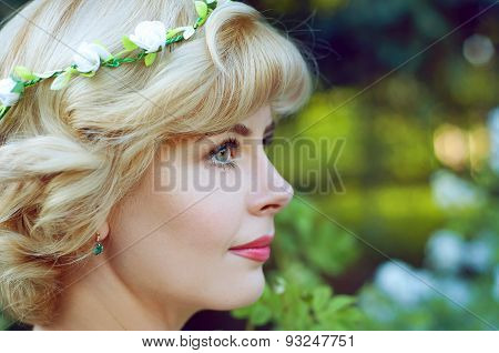 Beautiful Blonde Woman In White Sundress Posing In Garden