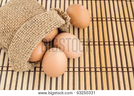 Egg In Burlap Sack On Wooden Background