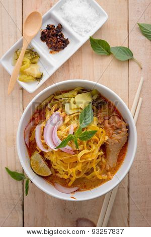 Curried Noodle Soup (khao Soi) With Coconut Milk On Wooden Table