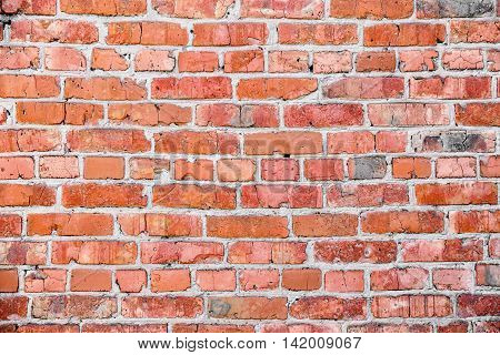 Old red brick wall texture with cracks