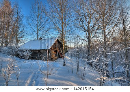 Hunting hut in winter forest at sunset extended dynamic Range