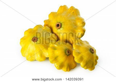 four yellow pattypan squashes on a white background isolated