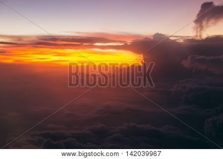 Photo of Lurid sky with clouds during sunrise. Air travel by plane. Soft focus