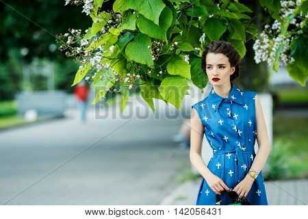 Beautiful Girl In Blue Dress In The Crosshairs With Purse
