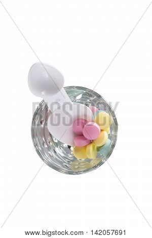 pills with a spoon in a glass