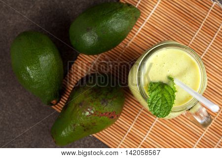 Avocado green smoothie and mint on bambo mat