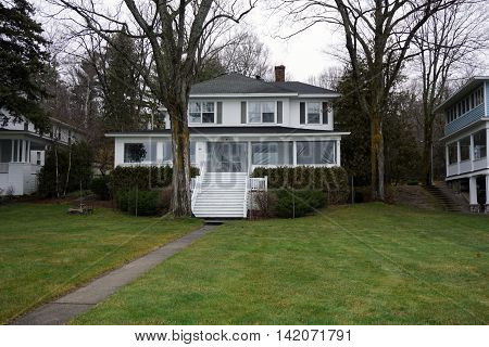 WEQUETONSING, MICHIGAN / UNITED STATES - DECEMBER 22, 2015: An elegant white home, christened Third Base, on Beach Drive in Wequetonsing.
