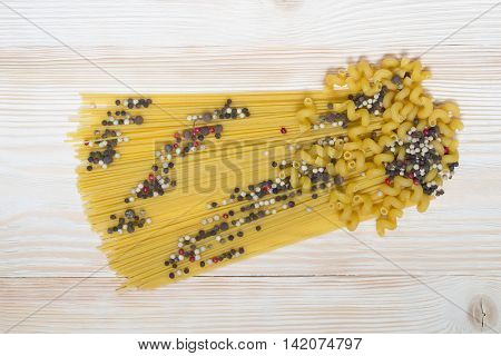 Pasta on the table with seasoning and pepper
