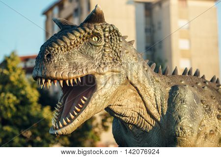 NOVI SAD SERBIA - AUGUST 5 2016: Carnotaurus life size model of prehistoric animal in theme entertainment Dino Park. This was bipedal predator measuring 8 to 9 m.