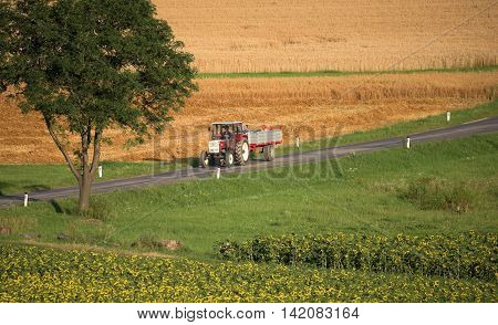 Harvesting of field in Austria countryside in summer
