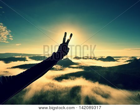 Man Hand Make Victory To Sun. Misty Daybreak In Mountains