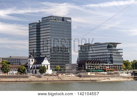 COLOGNE GERMANY - AUG 7 2016: Modern office buildings and the Rheinboulevard at the Rhine river bank in Cologne Germany
