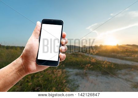 Hand using smartphone mobile in the vertical position, background blur of Beautiful landscapes