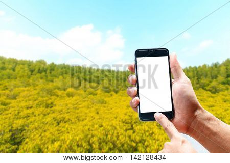 Hand using smartphone mobile in the vertical position, background blur of Beautiful landscapes