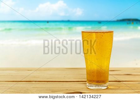 Beer glass on a blurred background of the sea.
