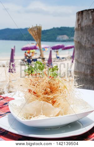 Appetizer of shrimp and cornflakes on the beach