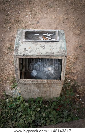 Garbage bin with ashtray in the park