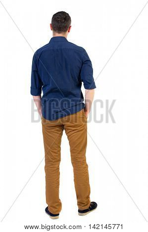 Back view of man . Standing young guy. Rear view people collection.  backside view of person.  Isolated over white background.a man in a blue shirt with the sleeves rolled up, standing with his hands