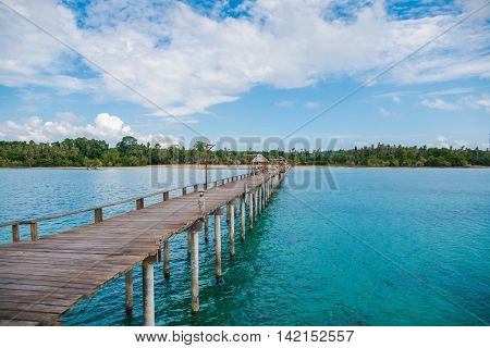 Jetty to a tropical beachJetty to a tropical beachJetty to a tropical beach with blue sky background